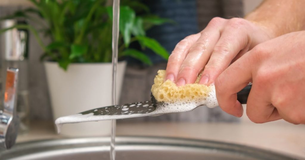 closeup-of-hands-washing-knife